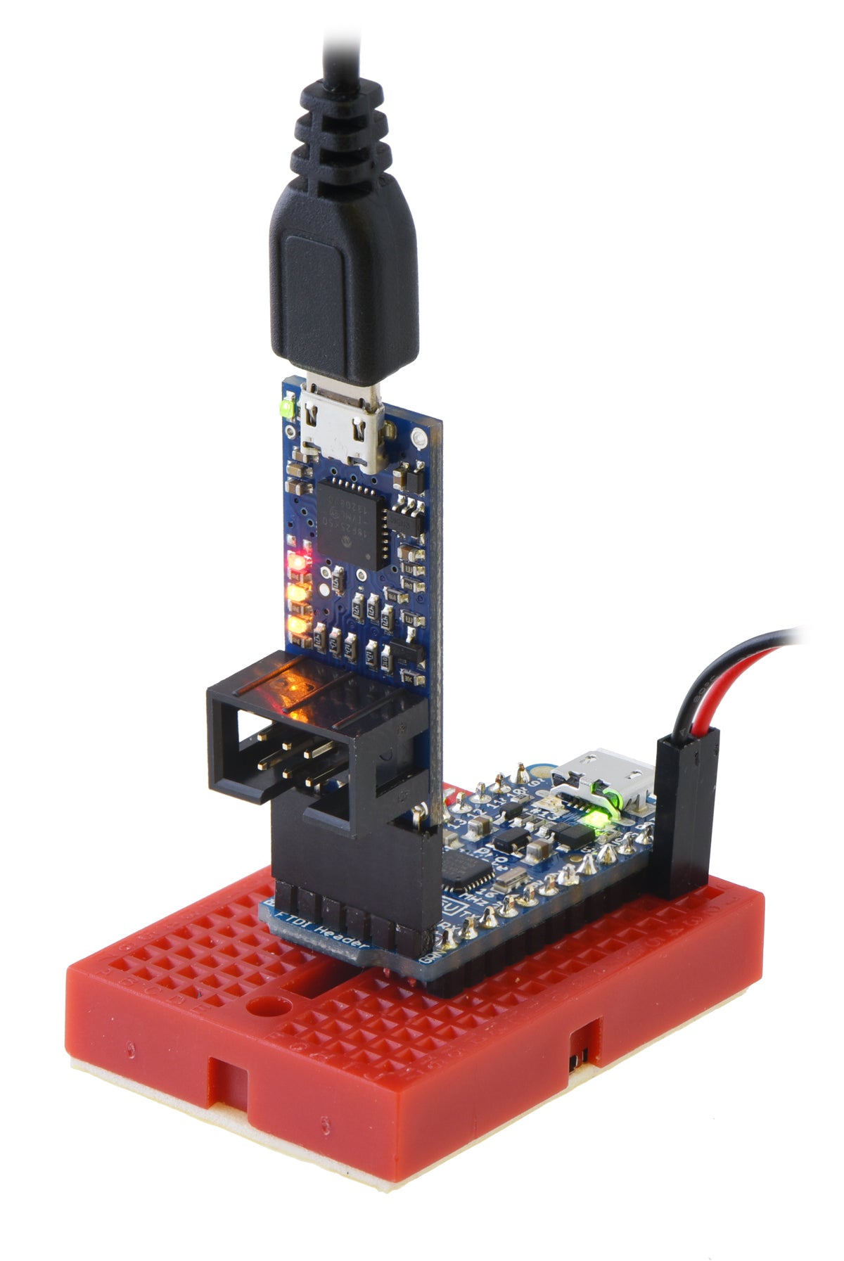 The Pololu USB AVR Programmer v2 (top) connected to an Adafruit Pro Trinket for programming.